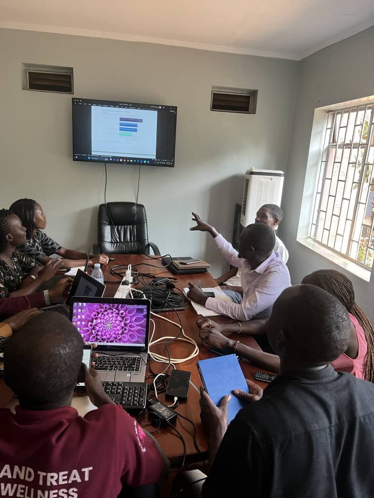 A facilitator and participants review a chart during a practical group discussion.